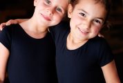 little ballerinas hugging and smiling in studio